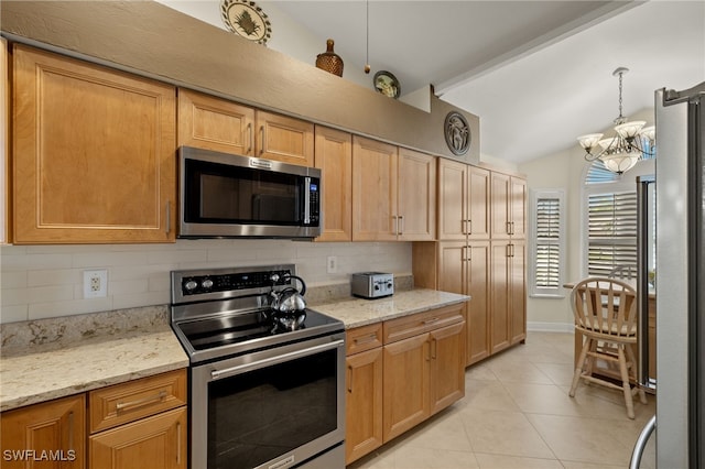 kitchen with appliances with stainless steel finishes, light tile patterned flooring, vaulted ceiling, and backsplash