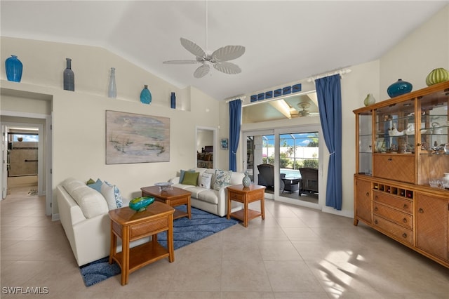 living room with ceiling fan, vaulted ceiling, and light tile patterned flooring