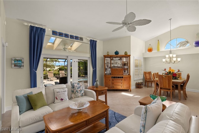 tiled living room featuring vaulted ceiling with skylight, baseboards, and ceiling fan with notable chandelier