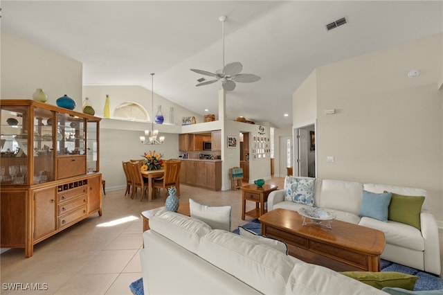 living area with high vaulted ceiling, ceiling fan with notable chandelier, visible vents, and light tile patterned flooring