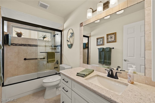 full bathroom featuring visible vents, bath / shower combo with glass door, toilet, tile patterned flooring, and vanity