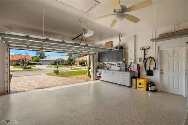 garage featuring ceiling fan and a garage door opener