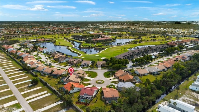 drone / aerial view with a water view, a residential view, and golf course view