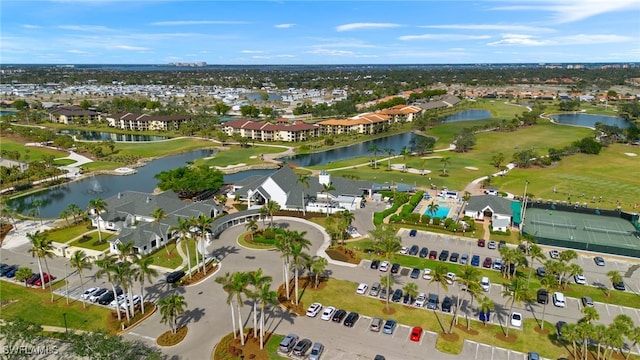 aerial view with a residential view, view of golf course, and a water view