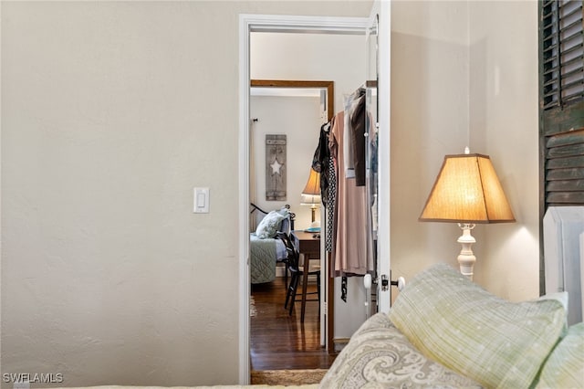 bedroom with dark hardwood / wood-style flooring