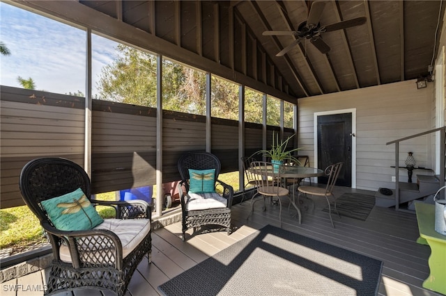 sunroom / solarium with ceiling fan, lofted ceiling, and a wealth of natural light