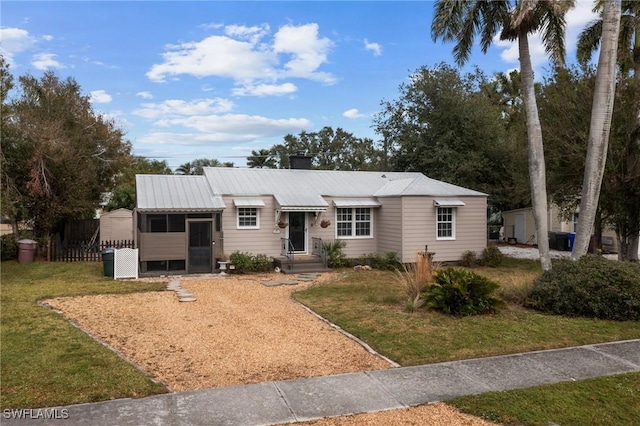 single story home with a front yard and a sunroom