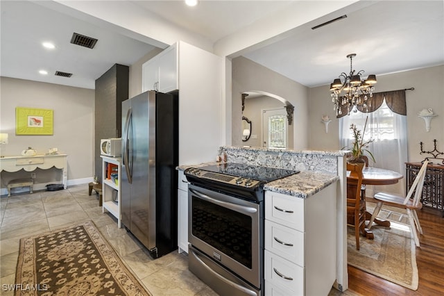 kitchen featuring white cabinets, a chandelier, hanging light fixtures, stainless steel appliances, and light stone countertops