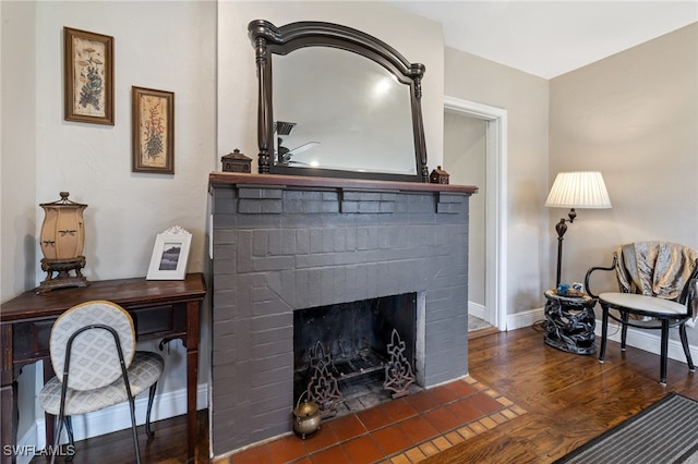 interior details with hardwood / wood-style floors and a brick fireplace