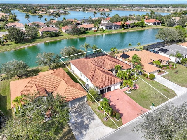 birds eye view of property with a water view and a residential view