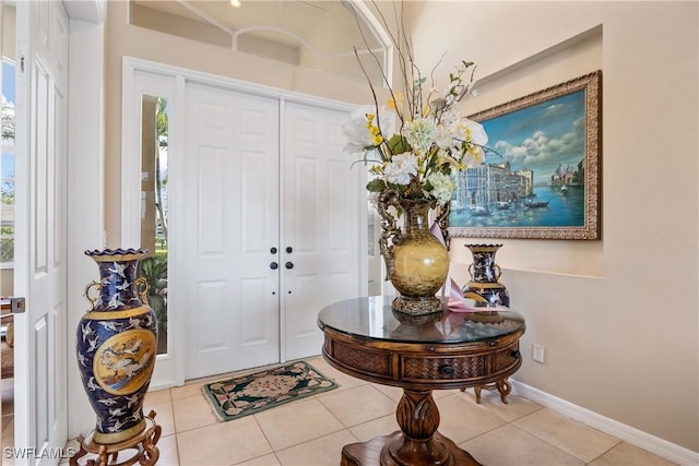 tiled foyer entrance featuring plenty of natural light and baseboards