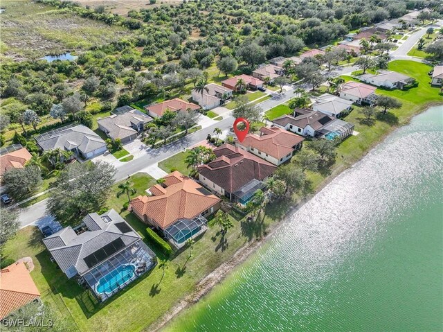 birds eye view of property with a water view