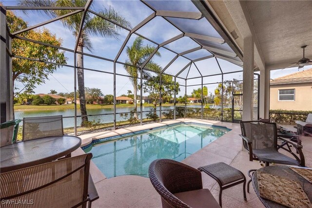 view of swimming pool featuring a water view, a lanai, and a patio area