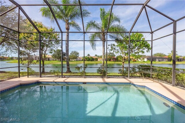 view of pool featuring a lanai and a water view