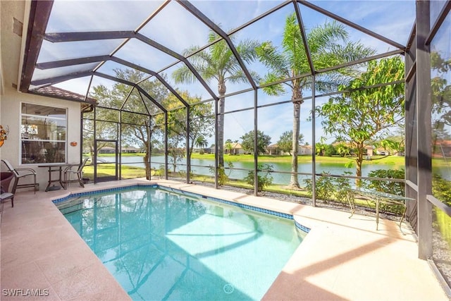 view of pool with a patio, a water view, and a lanai