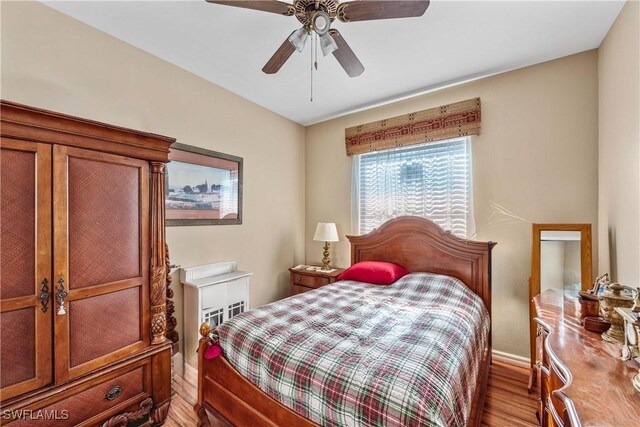 bedroom featuring hardwood / wood-style flooring and ceiling fan