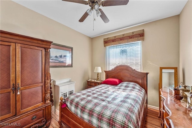 bedroom with ceiling fan and wood finished floors