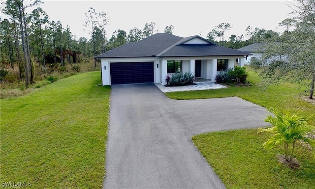 view of front of house with a front yard and a garage