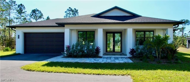 view of front of home featuring a front lawn and a garage