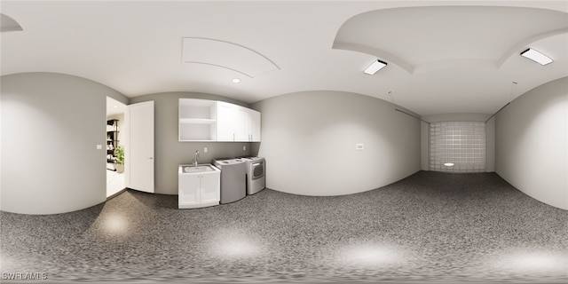 interior space featuring vaulted ceiling, washer and clothes dryer, and sink