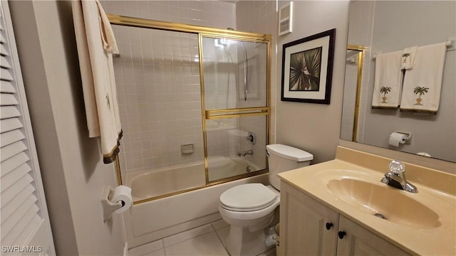 full bathroom with vanity, toilet, combined bath / shower with glass door, and tile patterned flooring