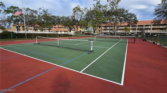 view of tennis court with basketball hoop