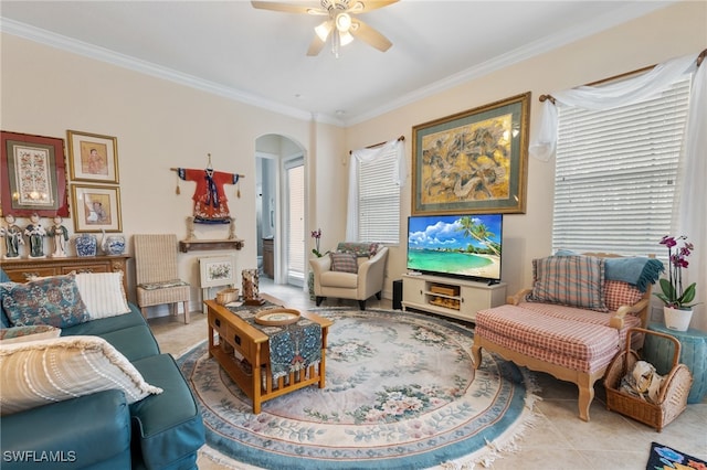 sitting room featuring ceiling fan, light tile patterned floors, and crown molding