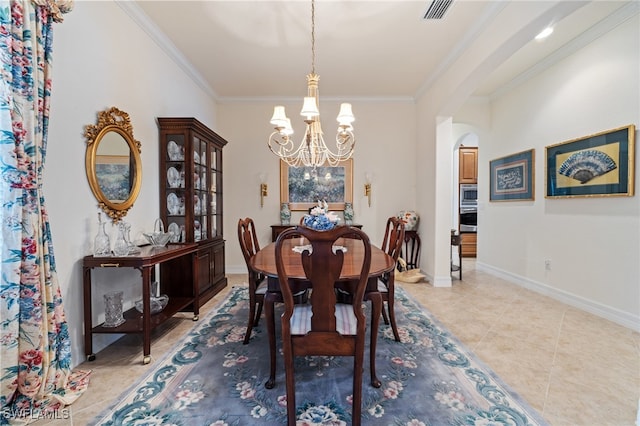 tiled dining room with ornamental molding and a chandelier