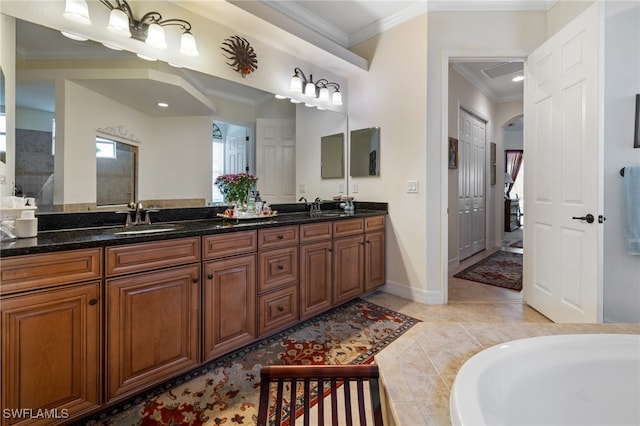 bathroom with crown molding, a bathtub, and vanity