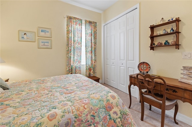 bedroom featuring light colored carpet and a closet