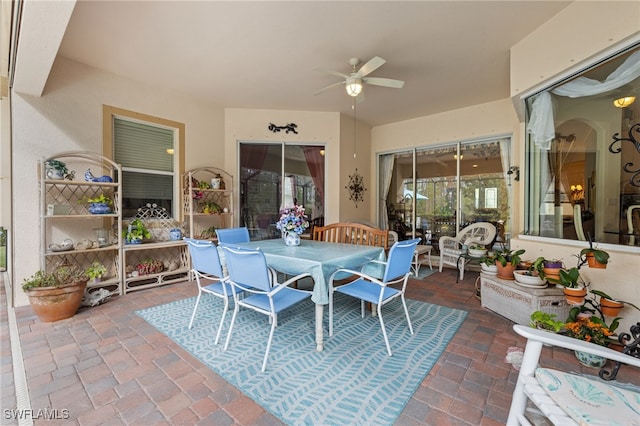 view of patio with outdoor dining area and ceiling fan