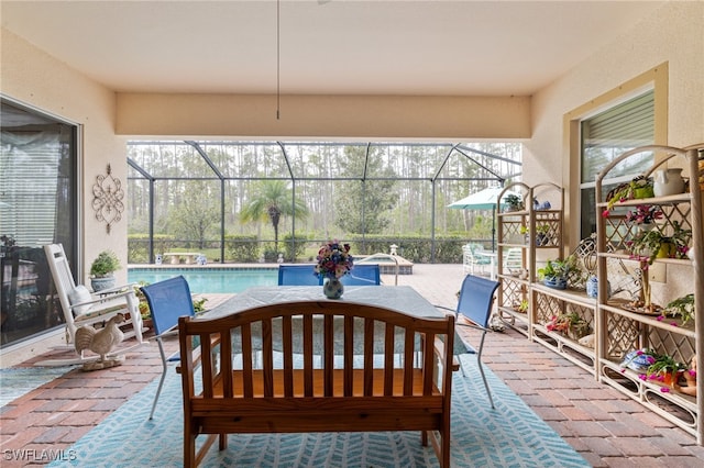 view of patio featuring a lanai