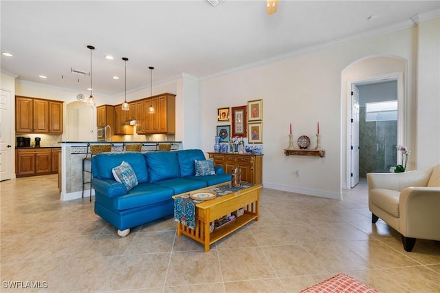 living room with arched walkways, baseboards, recessed lighting, and crown molding