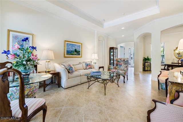 living area featuring light tile patterned flooring, crown molding, a raised ceiling, arched walkways, and recessed lighting