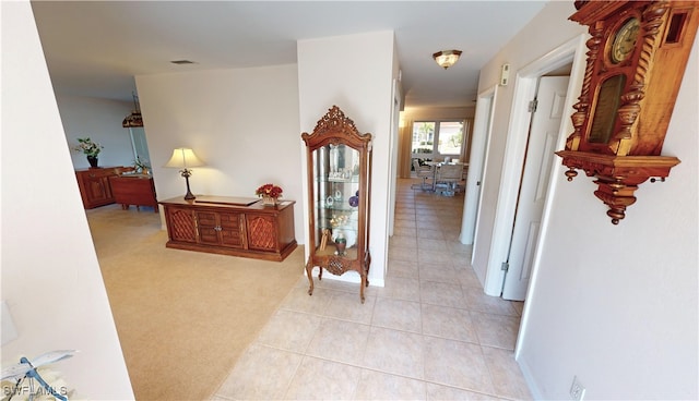 hallway with light colored carpet