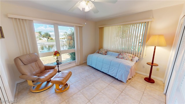 bedroom with ceiling fan and light tile patterned flooring