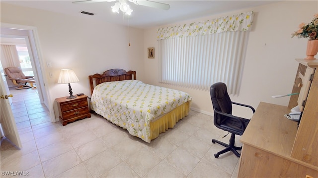 tiled bedroom featuring ceiling fan