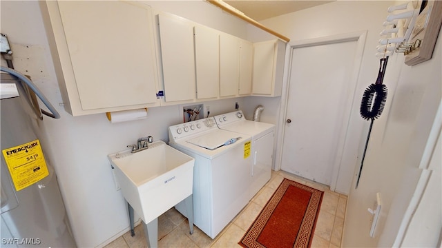 laundry area featuring cabinets, washer and dryer, electric water heater, and sink