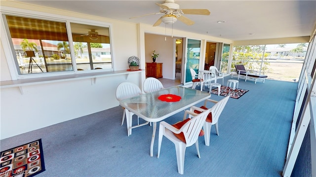 sunroom featuring ceiling fan