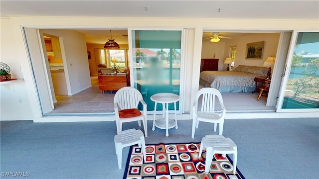 dining space with ceiling fan and carpet flooring