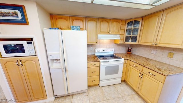 kitchen featuring light tile patterned floors, decorative backsplash, white appliances, light brown cabinetry, and light stone countertops