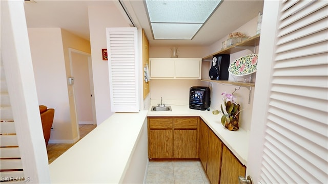 bar with sink and light tile patterned floors