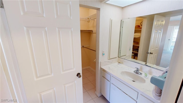 bathroom featuring tile patterned flooring and vanity