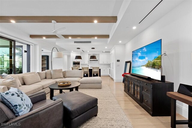 living room with light wood-type flooring and beam ceiling