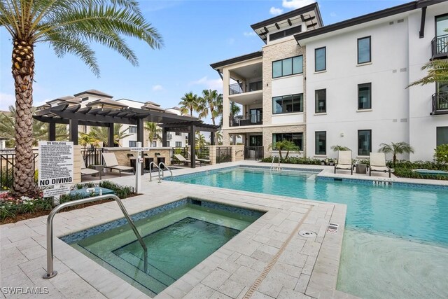 pool featuring a community hot tub, fence, a patio area, and a pergola