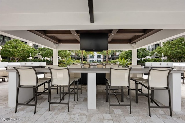 view of patio with outdoor wet bar and area for grilling