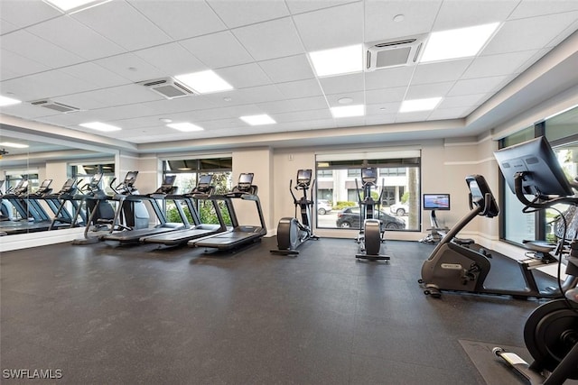 workout area with visible vents and a paneled ceiling