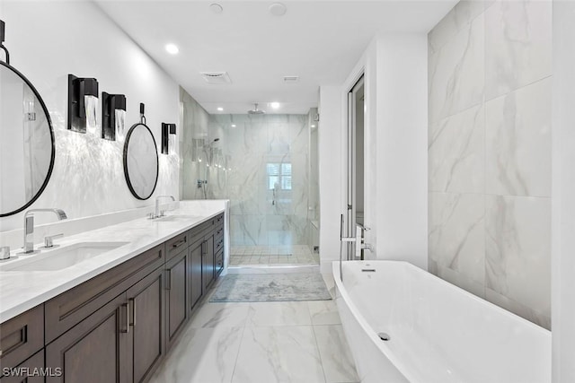 bathroom featuring a sink, a marble finish shower, a freestanding bath, and marble finish floor