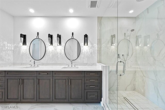 full bathroom with double vanity, visible vents, a shower stall, and a sink