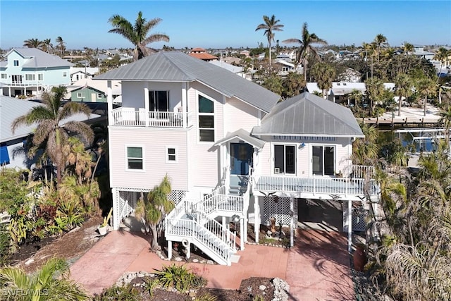 rear view of property with a carport and a balcony